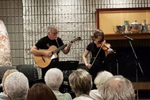 Violinist and guitarist perform in the Fireside lounge in the Art Gallery of Burlington